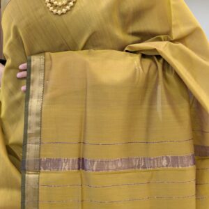 Close-up of sonsali golden Maheshwari silk-cotton saree with linear patterns, small zari border