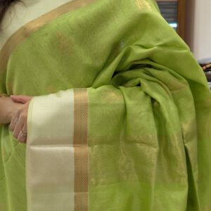 Close-up of pista green Maheshwari silk cotton saree with floral motifs, white resham border