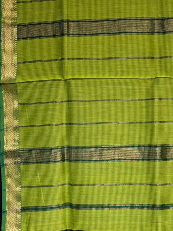 Detailed image of zari-lined pallu with shimmering golden stripes in classic Maheshwari weaving.