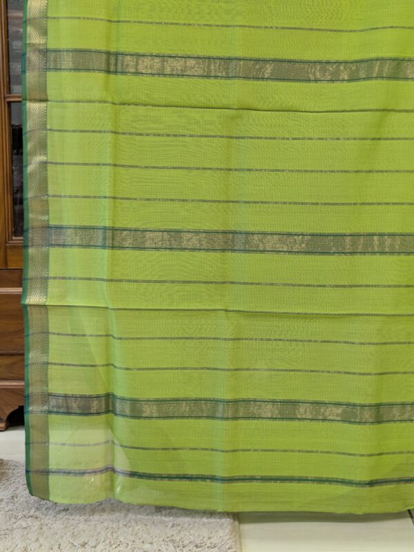Image of zari-lined pallu with shimmering golden stripes in classic Maheshwari weaving.