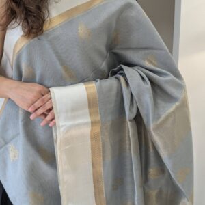 Close-up of grey Maheshwari silk cotton saree with flower motifs, white resham border