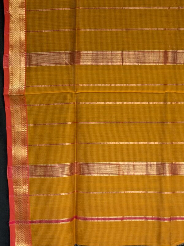 Detailed image of zari-lined pallu with lustrous golden stripes woven in classic Maheshwari style.