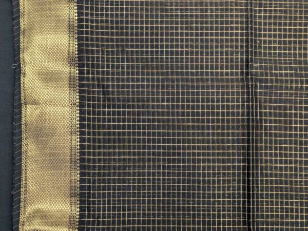 Close-up of black Maheshwari silk-cotton saree with zari checks, medium border