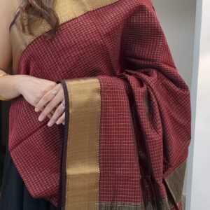 Close-up of maroon Maheshwari silk-cotton saree with zari checks, medium border