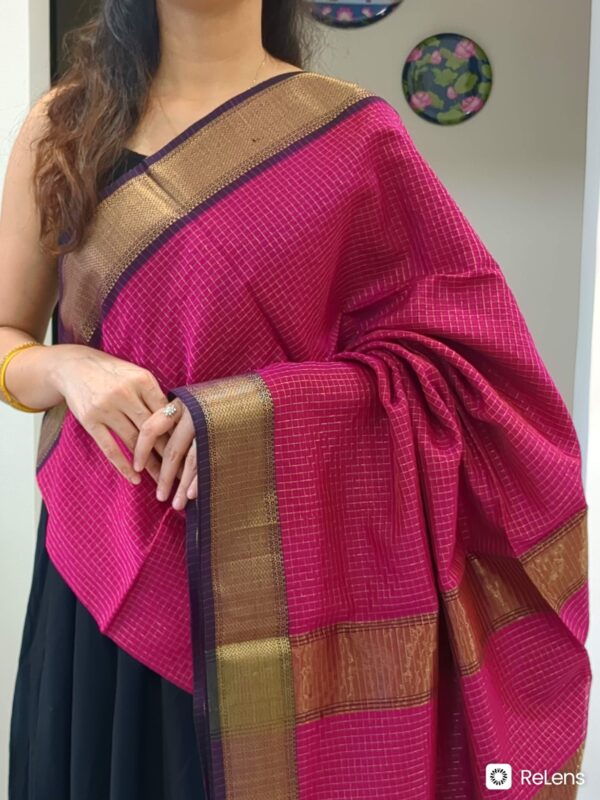 Close-up of dark rani pink Maheshwari silk-cotton saree with zari checks, medium border