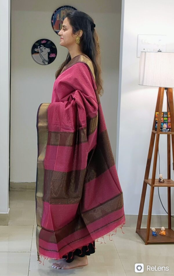 Side view of onion pink saree showing rich drape, traditional weave, and subtle shimmer.
