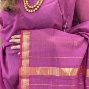 Close-up of onion pink Maheshwari silk-cotton saree with striped pattern, small zari border