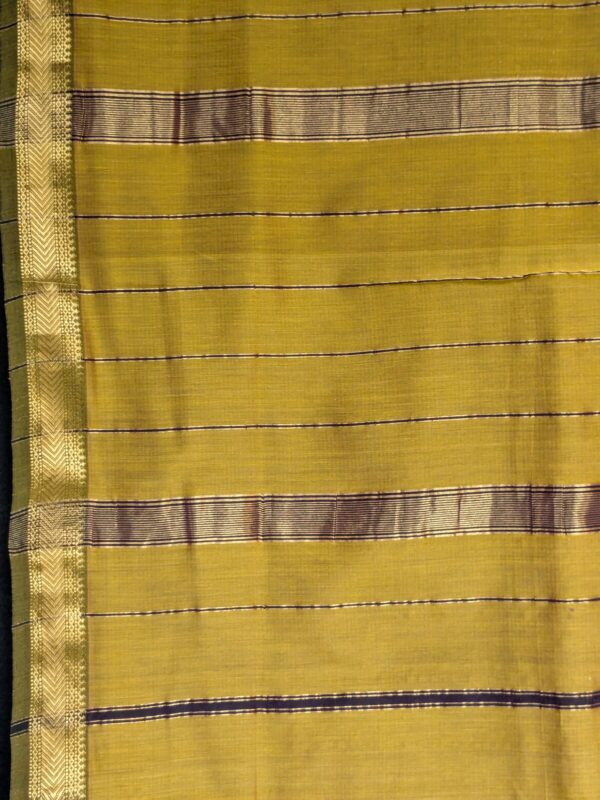 Detailed image of zari-lined pallu with fine golden stripes and refined handloom finish.