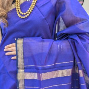 Close-up of violet Maheshwari silk-cotton saree with striped pattern, small zari border