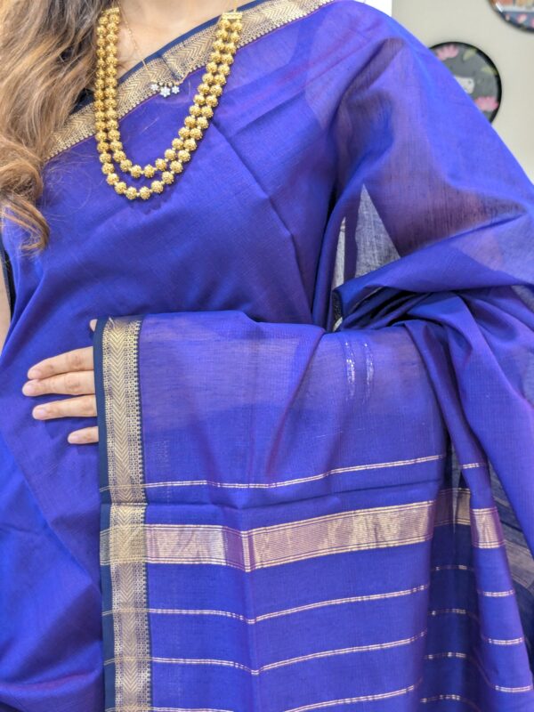 Close-up of violet Maheshwari silk-cotton saree with striped pattern, small zari border