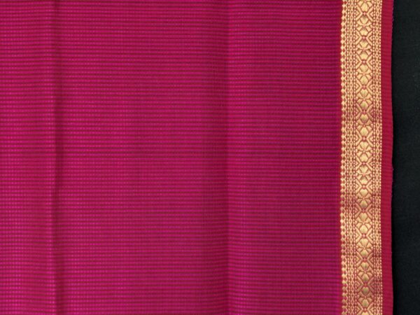 Close-up of hot pink Maheshwari saree with small checks, vintage-style pallu, and small zari border in silk-cotton blend.