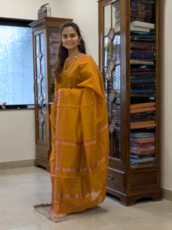 Full front view of handloom Maheshwari saree in rich gold featuring striped design and subtle sheen.