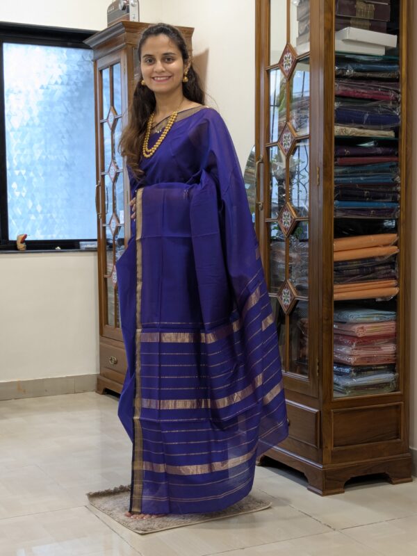 Full front view of handloom violet Maheshwari saree showcasing linear design and subtle traditional elegance.