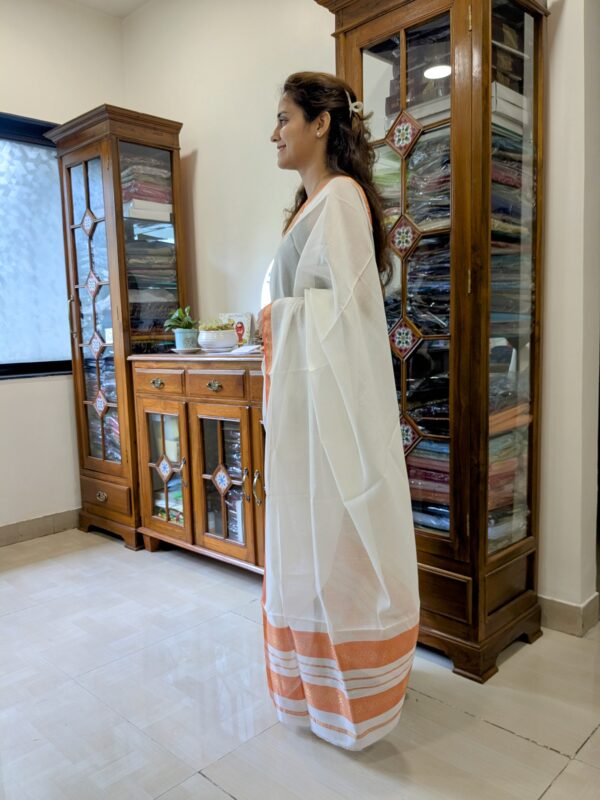 Side view of lightweight handloom saree in white showcasing soft drape and refined finish.