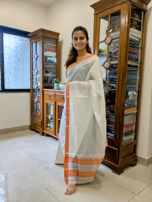Full front view of elegant white silk-cotton Maheshwari saree with subtle checked pattern and traditional charm.