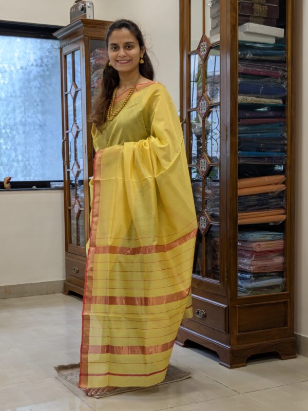 Full front view of handloom yellow Maheshwari saree featuring linear design and subtle festive shimmer.