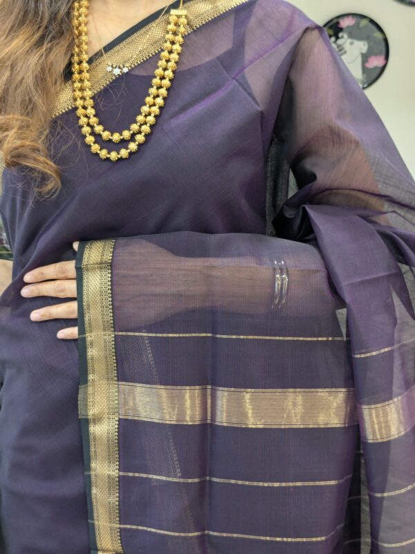 Close-up of black Maheshwari silk-cotton saree with linear design, small zari border