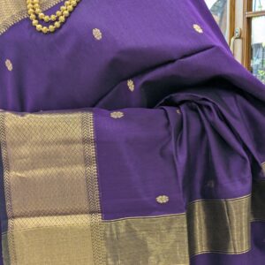Close-up of purple Maheshwari silk cotton saree with flower butti, wide-narrow border