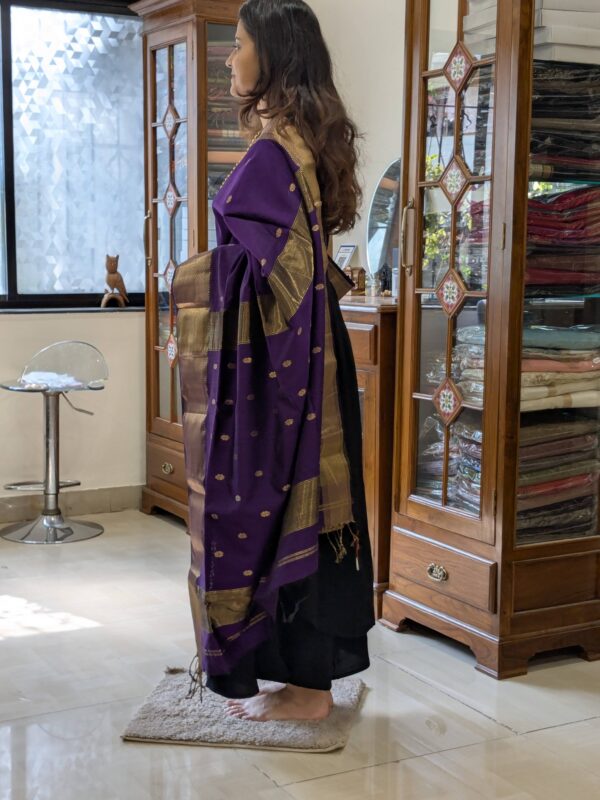 Side view showing the elegant drape and handwoven texture of the purple silk cotton saree.